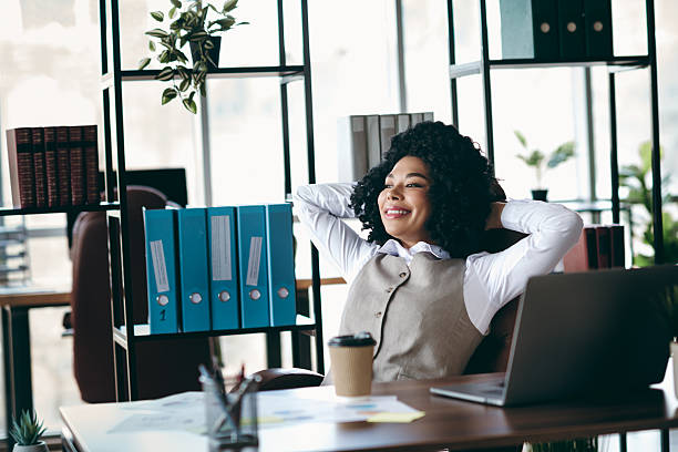 istock Confident Businesswoman Relaxing in a Stylish Office Workspace, Reflecting on a Successful Career Path 2216400663