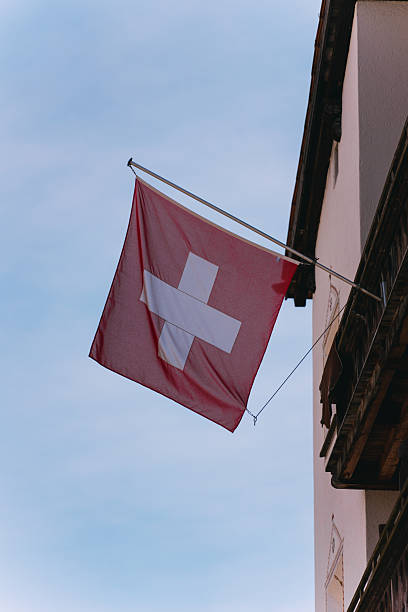istock Swiss flag hanging from a building in switzerland 2216400978