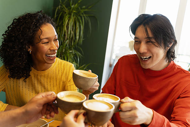 istock Friends Enjoying Coffee Together in a Cafe 2216401148