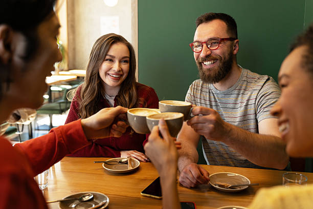 Friends toasting cappuccino in a cafe