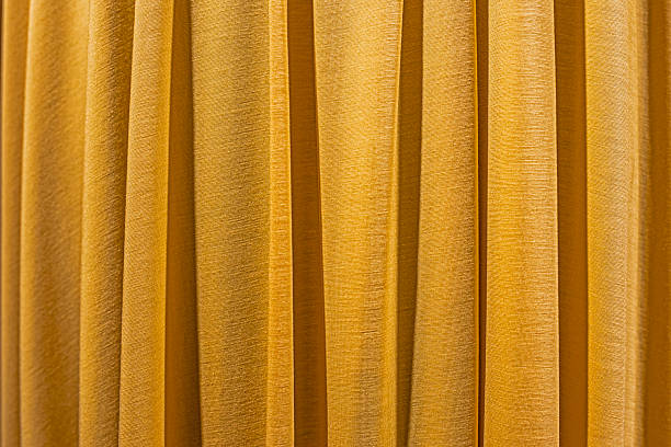 istock fabric golden yellow background with folds 2216402159