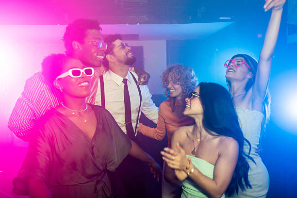 istock Friends enjoying nightlife, dancing at disco party 2216403641