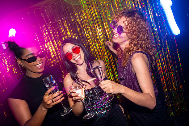 istock Three young women toasting with champagne at a disco party 2216403686