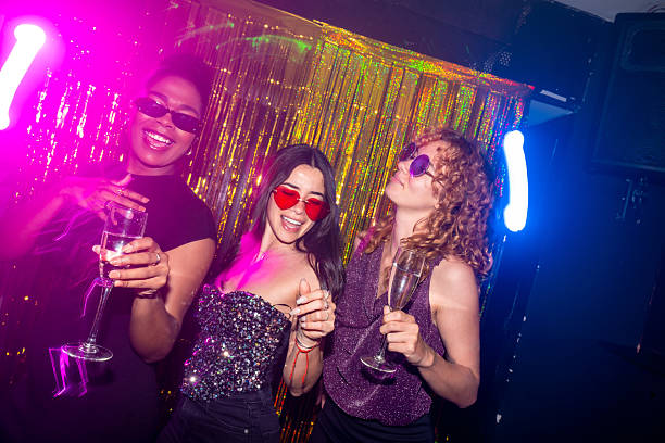 istock Three young women enjoying drinks at a nightclub party 2216403767