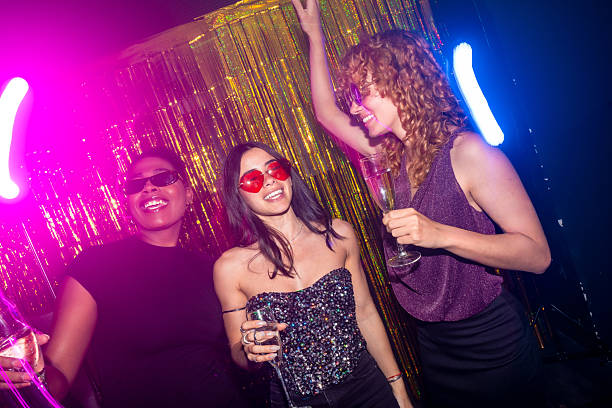istock Young women enjoying party, drinking champagne and dancing 2216403770