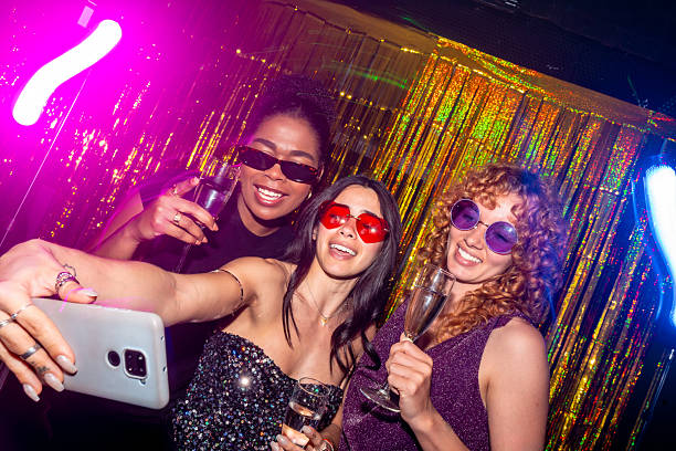 istock Cheerful women taking selfie at disco party 2216403855