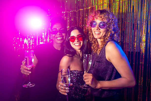 istock Three young women enjoying drinks at a nightclub party 2216403864