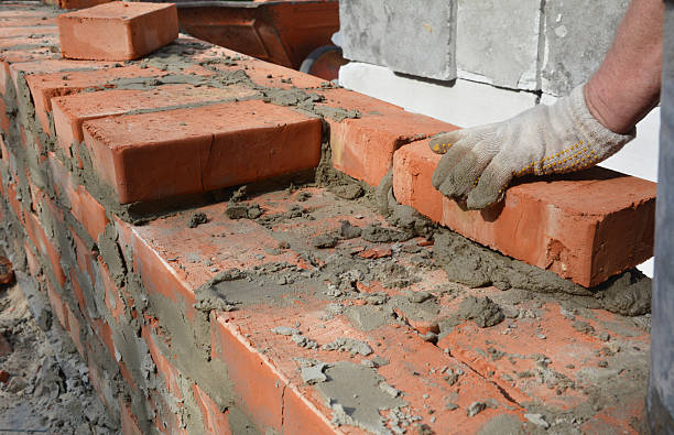 istock Mason bricklaying house brick wall close up 2216404935