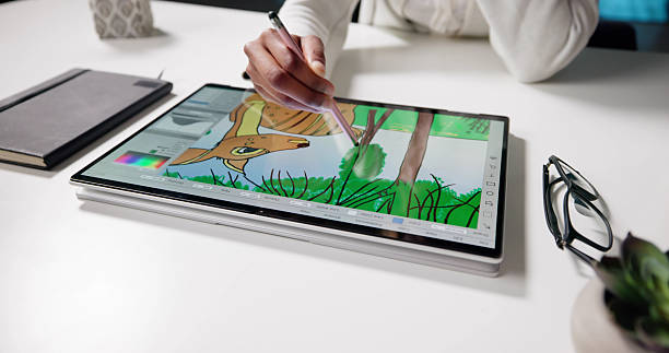 istock African-American Woman Creating Digital Art On Tablet 2216405795