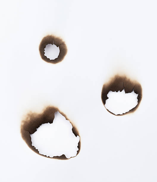 istock The white paper was burned with holes 2216406419