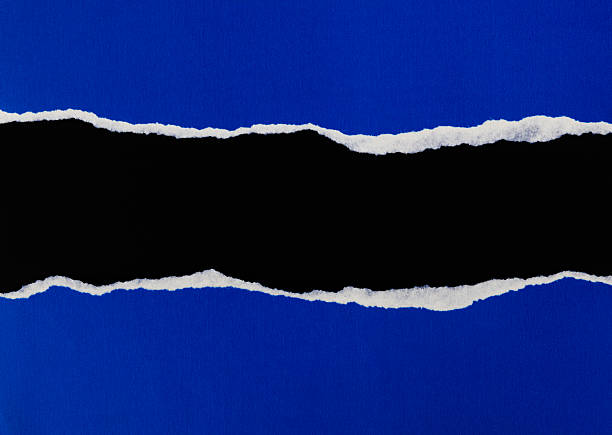 istock Torn blue paper revealing black background 2216406459