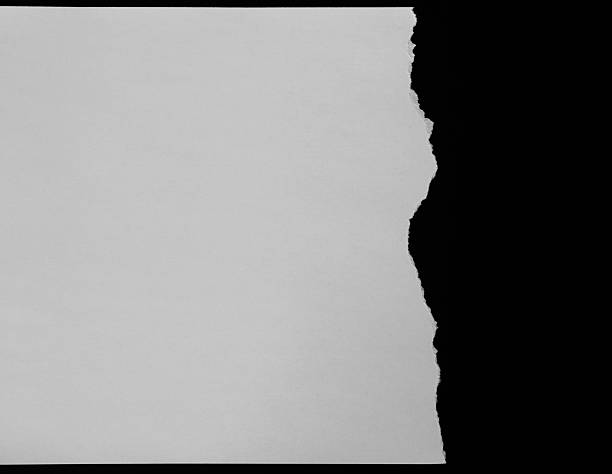 istock A piece of torn white paper on black background 2216406465
