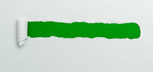 istock Tear open the white paper on the green paper 2216406522