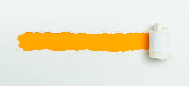 istock Tear open the white paper on the orange paper 2216406524