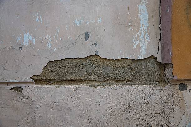 istock Damaged plaster wall with cracks and peeling surface – need for renovation 2216406640