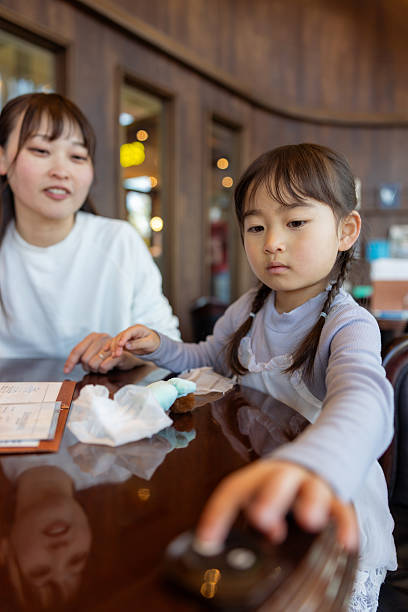 Girl pressing button to call a restaurant staff
