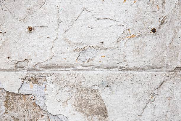 istock Damaged plaster wall with cracks and peeling surface – need for renovation 2216406996