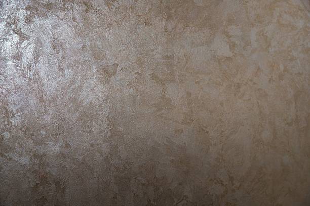 Elegant decorative plaster texture with pearlescent finish, beige wall background for interior design and architecture themes