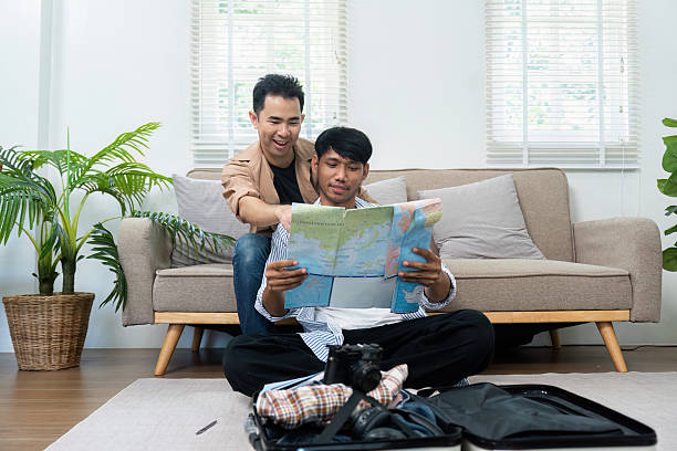 istock Exploring Destinations and Togetherness. A couple studies a map, excitedly planning their travel route for an upcoming adventure. 2216407947
