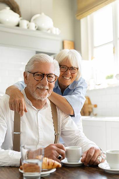 istock Affectionate senior couple enjoying breakfast together at home 2216408032