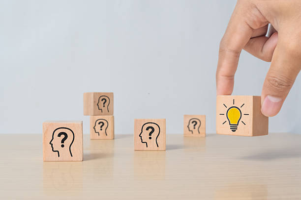 istock Hand picking wooden cube with light bulb and human head icon. Concept of creative idea, innovation, and thinking strategy in business. 2216408107