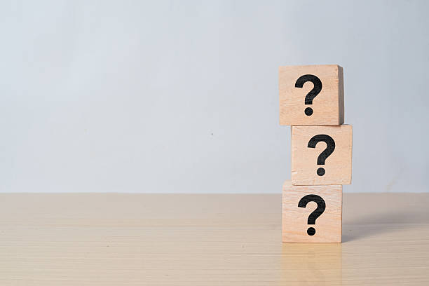 istock Wooden cube block shape with sign question mark symbol on wood table 2216408381