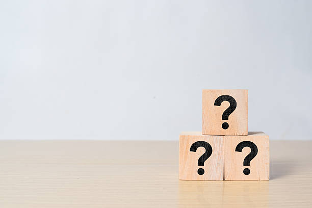 istock Three wooden cube block shape with sign question mark symbol on wood table 2216408407