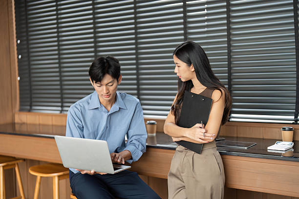 istock Business Consultation and Collaboration. Two young professionals discussing work-related topics in an office. 2216410804