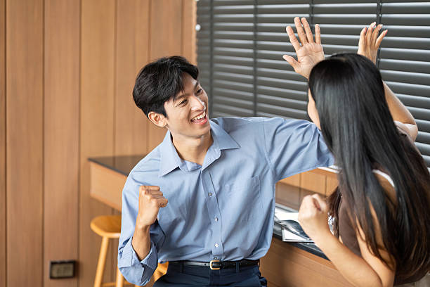 istock Joyful Business Interaction. Two colleagues celebrating a successful idea in a contemporary office. 2216410870