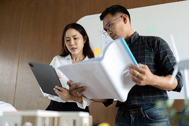 istock Sustainability and Engineering. Team of engineers discussing eco-friendly project plans in an office. 2216412662