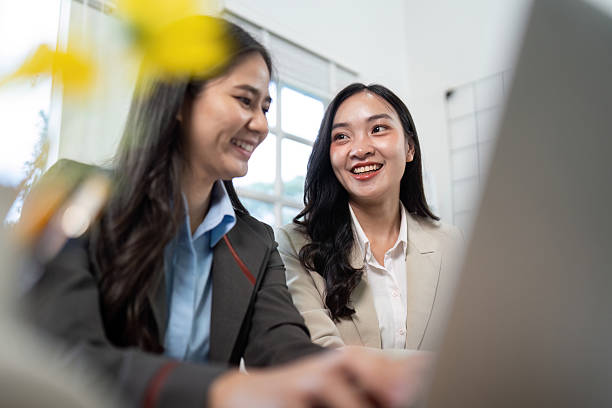 istock Engaging Discussion. Two businesswomen sharing insights while working on a laptop. 2216412923