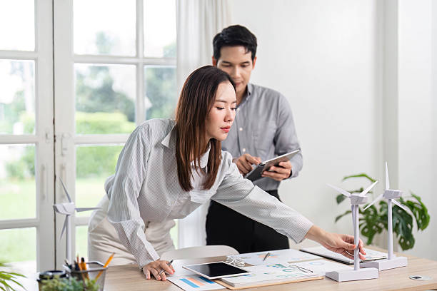 istock ESG and Business Engagement. Professionals analyzing renewable energy concepts in a bright office. 2216413877