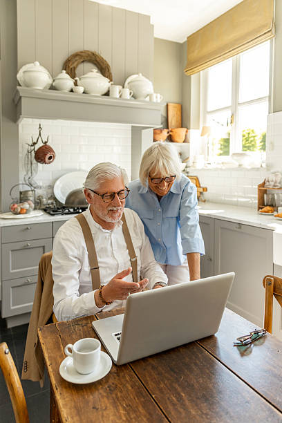 istock Independent affectionate senior couple using a laptop in their home 2216414485