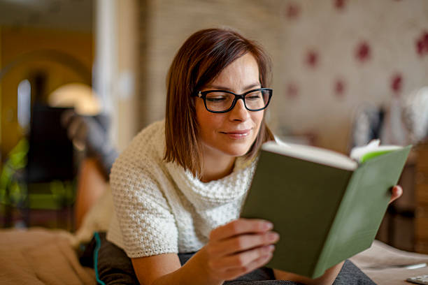 istock Woman reading at home 2216415625