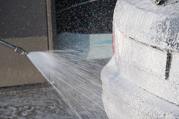 Applying foam close-up on car wash, horizontal photo.
