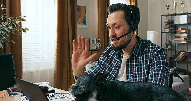 istock A happy male employee in a plaid shirt completes final documents at his desk, telling a colleague about a new bank client who loved the proposal, feeling proud of the successful deal. 2216419741