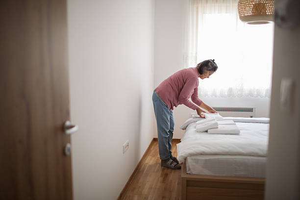 istock Housekeeper making the bed at rental apartment 2216422971