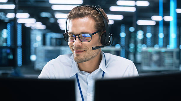 istock Call Center Worker Wearing Headset Working in Office to Support Remote Customer. Call Center, Telemarketing, Customer Support Agent Provide Service on Video Conference Call. 2216426591