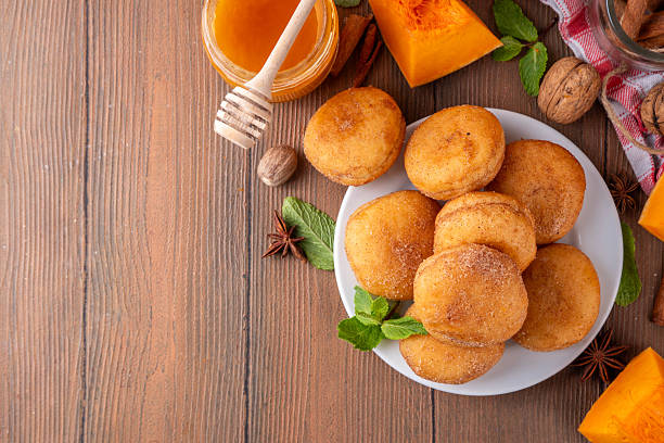 istock Autumn pumpkin pie donuts with cinnamon sugar sprinkled topping 2216428343