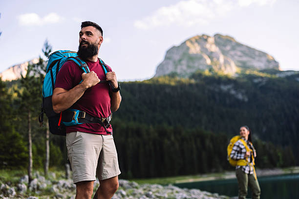 istock Hikers walking near lake in mountain valley during summer vacation 2216429032