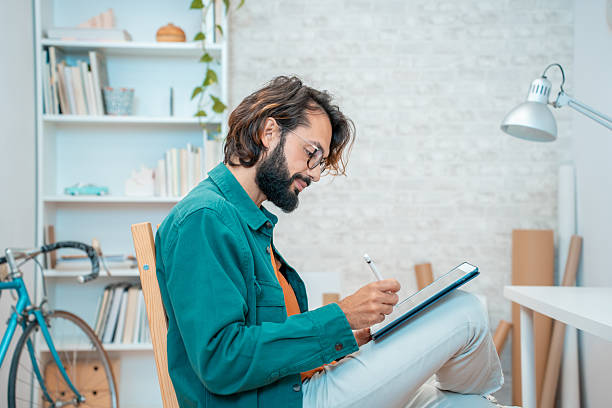 istock Creative Man Engaged in Sketching Inside a Modern and Stylish Workspace Environment 2216429335