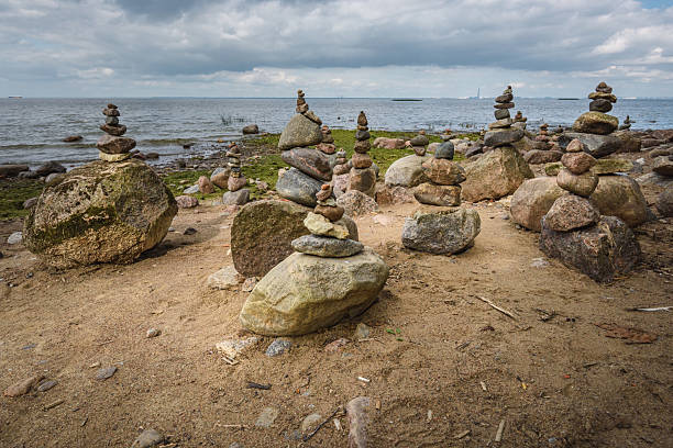 istock Rock pyramids on the seashore in a public park. 2216467468