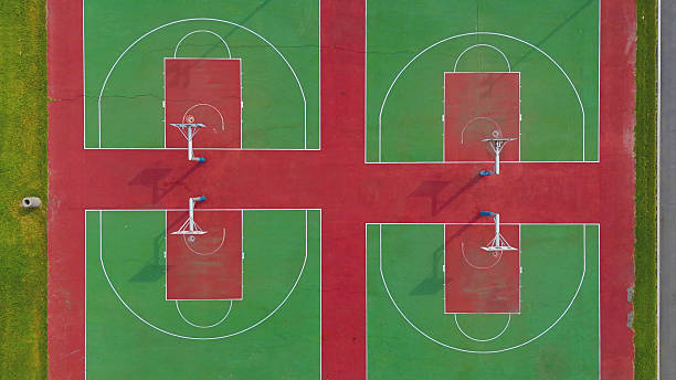 istock Multiple Outdoor Basketball Courts with Hoop Shadows, Overhead View 2216468046