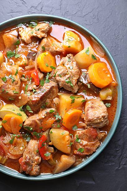 istock Delicious stew with vegetables on black table, top view 2216468224