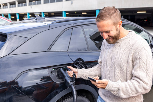 istock Man using smartphone to pay for electric vehicle charging 2216468246