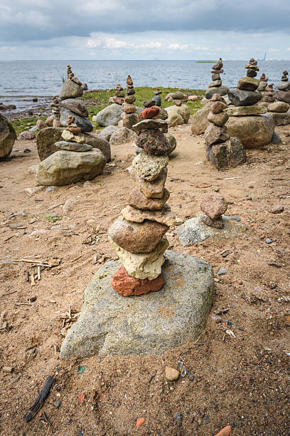 istock Rock pyramids on the seashore in a public park. 2216468561