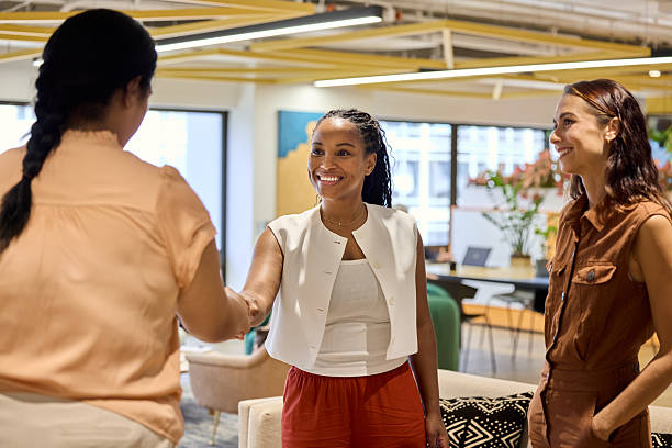 istock Businesswoman doing handshake with colleague 2216468759