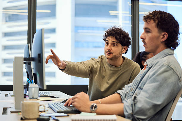 istock Male business professionals working together at office 2216469491