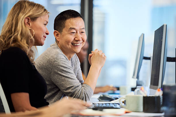 Happy mature businessman talking with colleague