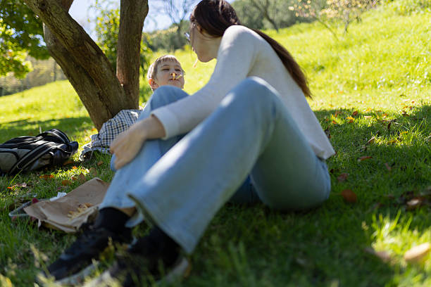 istock Mother and son enjoying a sunny day picnic under a tree 2216470326